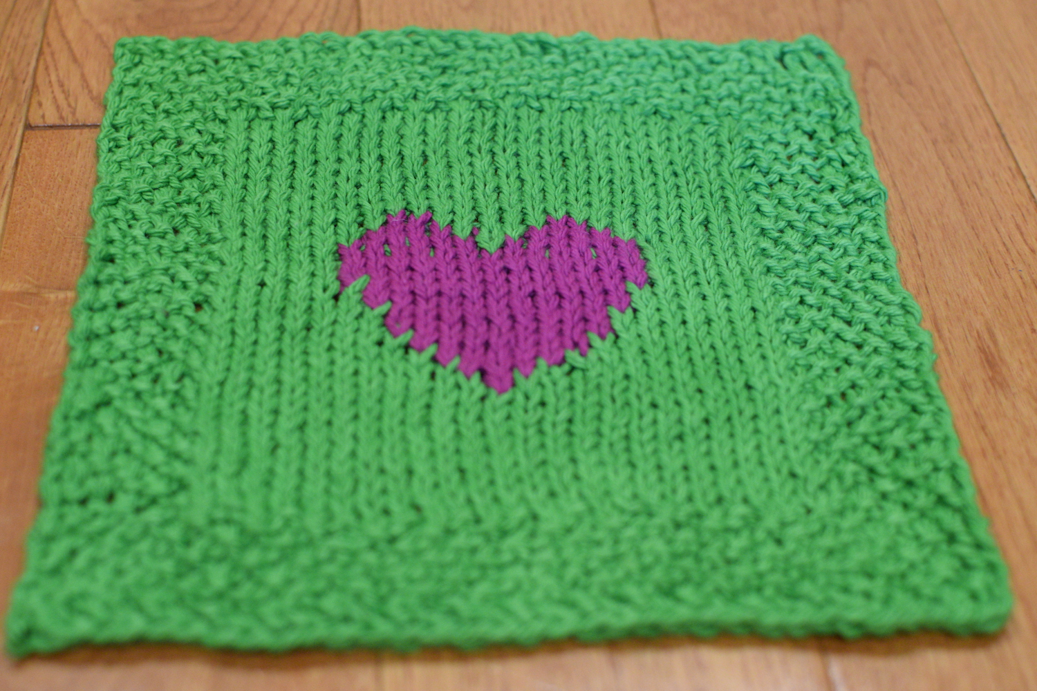 Easy to knit heart dishcloth using 2 colors.  The heart is sitting in the center and surrounded by seed stitch border.  